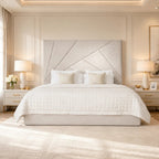 Luxury upholstered bed with geometric headboard, white quilted bedding, and matching nightstands in elegant bedroom