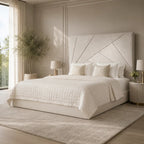 Luxury upholstered bed with geometric headboard, white quilted bedding, and modern bedside lamps in serene bedroom.