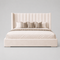 Luxury upholstered bed with tufted headboard, striped pillows, and neutral bedding for modern bedrooms