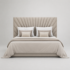 Luxury upholstered bed with tufted headboard, neutral bedding, and striped accent pillows