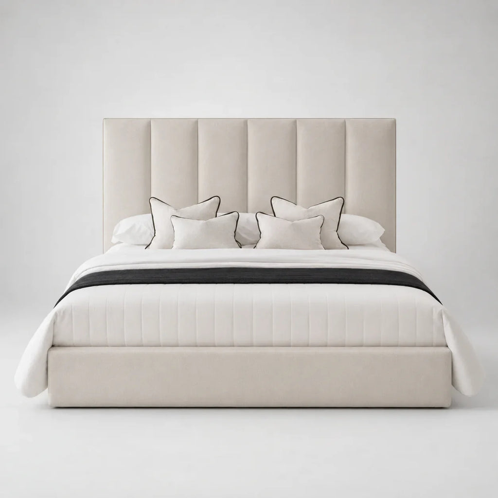Luxury beige upholstered bed with tufted headboard, white bedding, and black trim accents