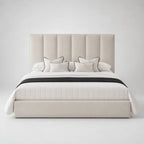 Luxury beige upholstered bed with tufted headboard, white bedding, and black trim accents