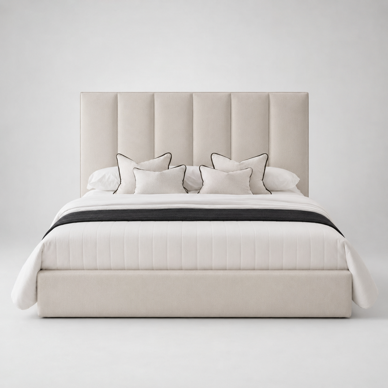 Luxury beige upholstered bed with tufted headboard, white bedding, and black trim accents