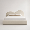Luxury upholstered bed with curved headboard, white bedding, and beige textured fabric