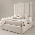 Luxury beige upholstered bed with tall tufted headboard, plush pillows, and cozy throws for modern bedroom decor