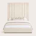 Luxury beige upholstered bed with tall panel headboard, white bedding, and decorative pillows