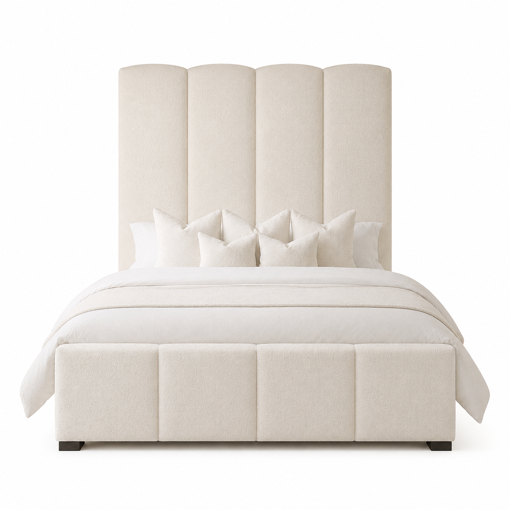 Luxury upholstered bed with scalloped headboard and matching footboard, styled with white bedding