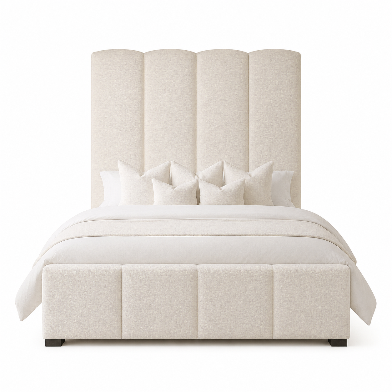 Luxury upholstered bed with scalloped headboard and matching footboard, styled with white bedding