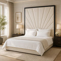 Luxury bed with cream sunburst headboard, white linens, and dark wood nightstands in modern bedroom