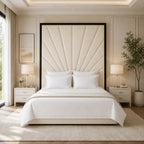 Luxury bed with tufted headboard, white linens, and modern bedside tables in a bright bedroom