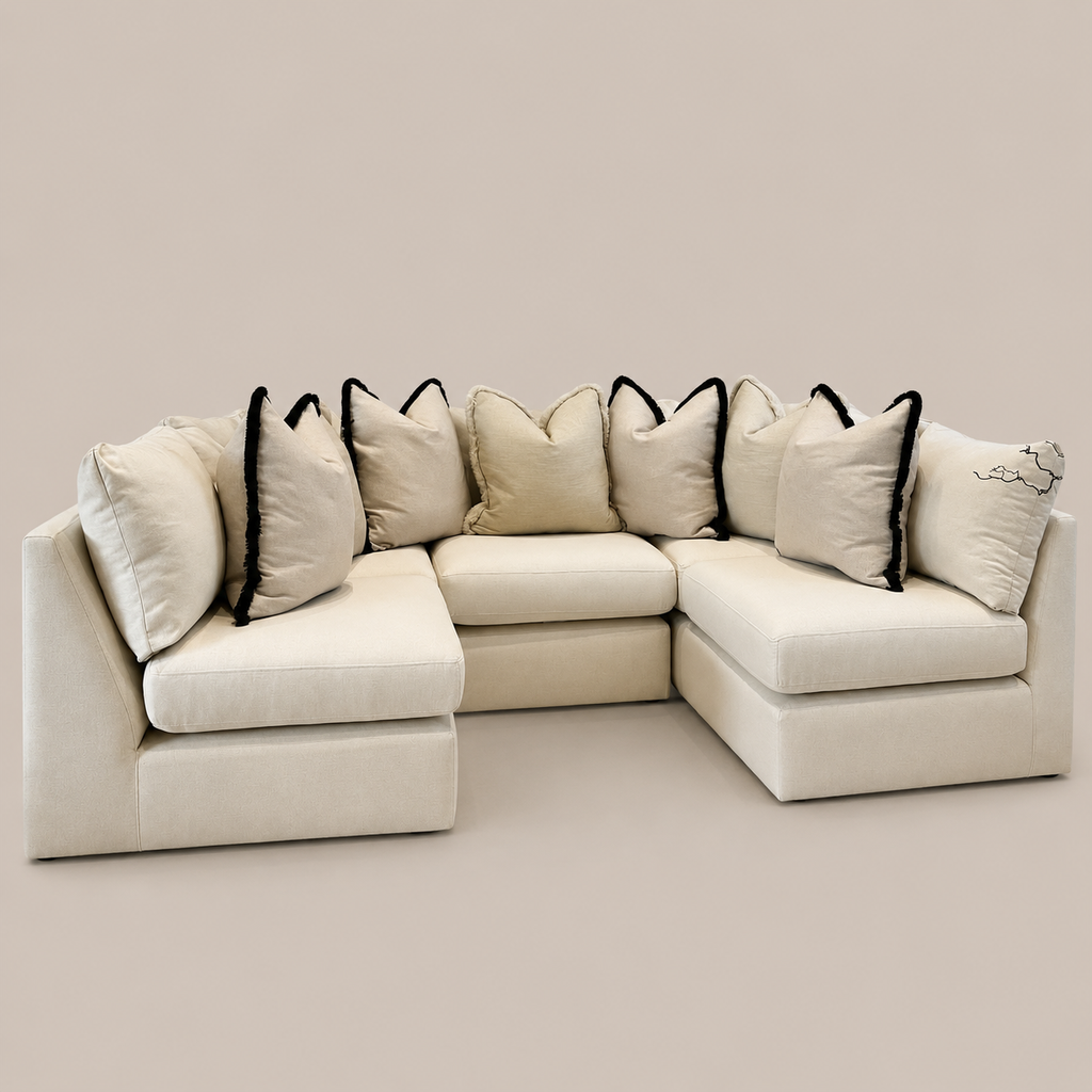 Cream modular sectional sofa with black-trimmed pillows, luxury living room furniture