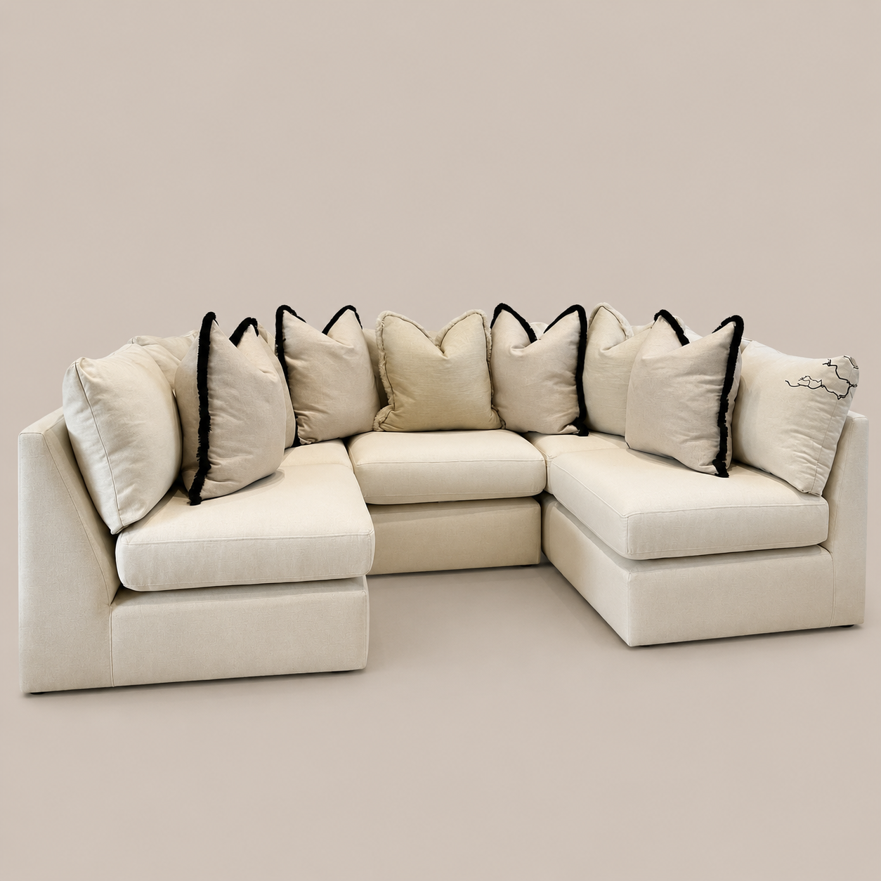 Cream modular sectional sofa with black-trimmed pillows, luxury living room furniture
