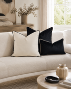 Cream sofa with black and white velvet throw pillows in modern living room