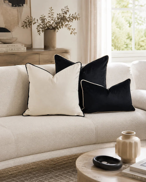 Cream sofa with black and white velvet throw pillows in modern living room