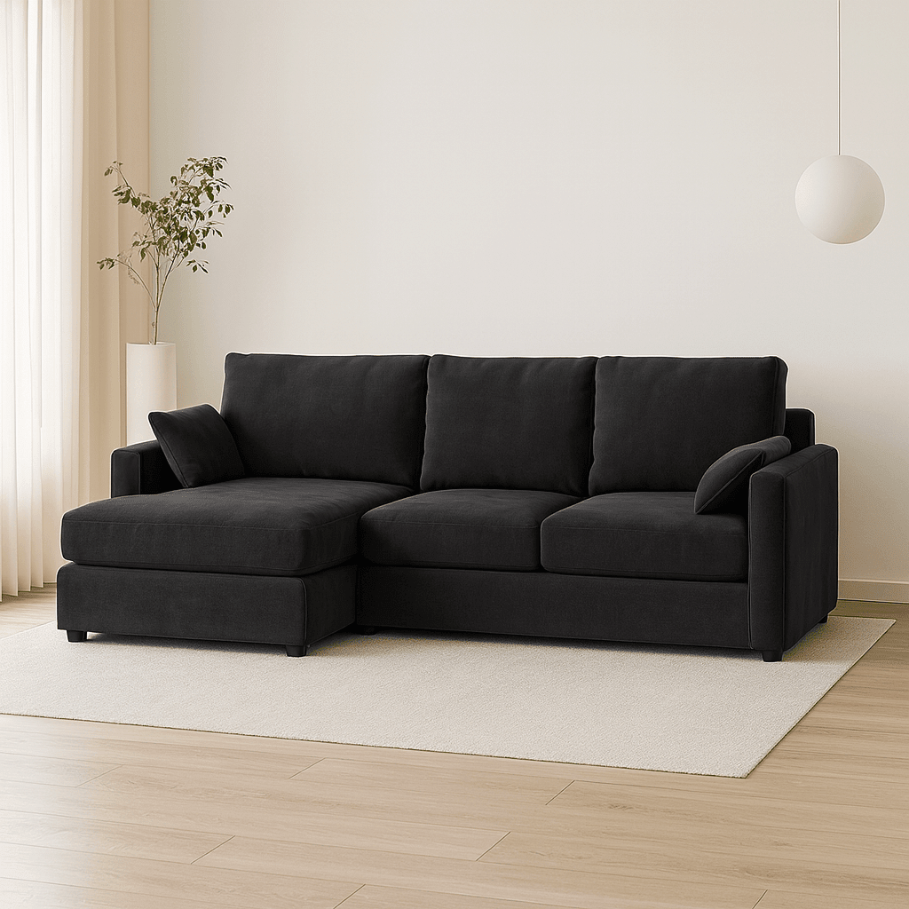 Modern black sectional sofa in minimalist living room with light wood floor