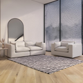 Modern white textured sofa and armchair set in stylish living room with zebra rug and arched mirror