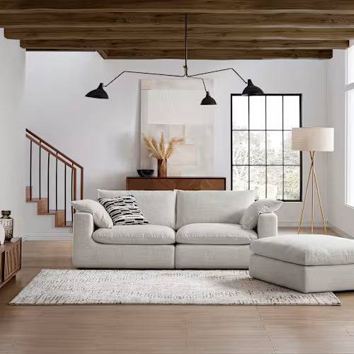 Modern 3-seater beach linen sofa with chaise in a stylish, minimalist living room setting