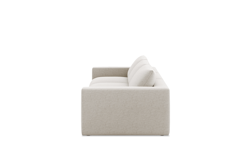 Side view of a modern extended beige linen sofa with plush cushions