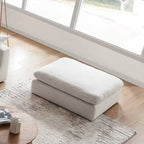 Square ottoman with beach linen fabric on modern rug in sunlit living room