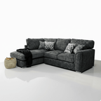 Dark grey corner sofa with plush cushions, patterned throw pillows, and modern design