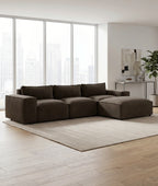 Modern brown sectional sofa in a spacious lounge with large windows and neutral decor