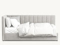 Modern grey upholstered bed with plush, vertical-stitched headboard and white bedding
