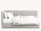 Modern grey upholstered bed with plush, vertical-stitched headboard and white bedding