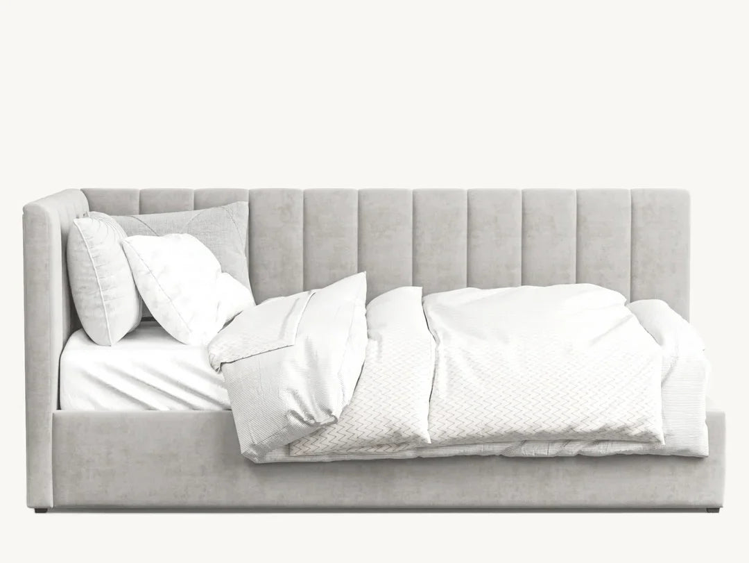 Modern grey upholstered bed with plush, vertical-stitched headboard and white bedding
