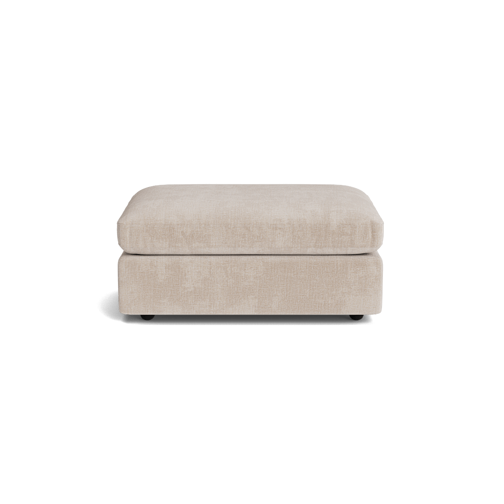 Beige fabric ottoman with plush cushion, modern living room furniture.