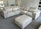 Modern light grey sectional sofa with matching ottoman in contemporary living room