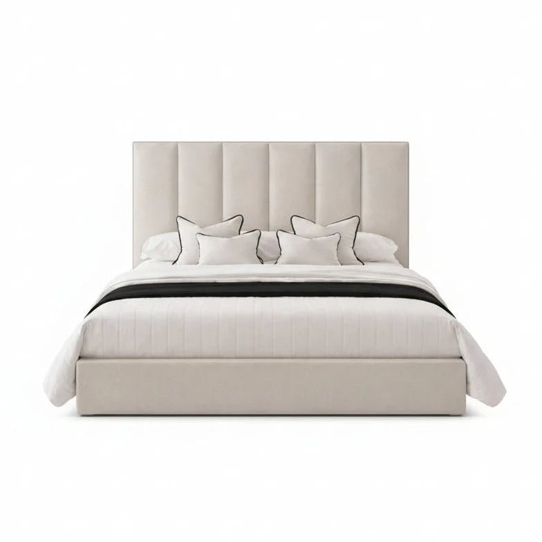 Modern upholstered bed with vertical panel headboard and plush pillows on white background