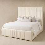 Luxury cream upholstered bed with tufted headboard and base, styled with white bedding and pillows