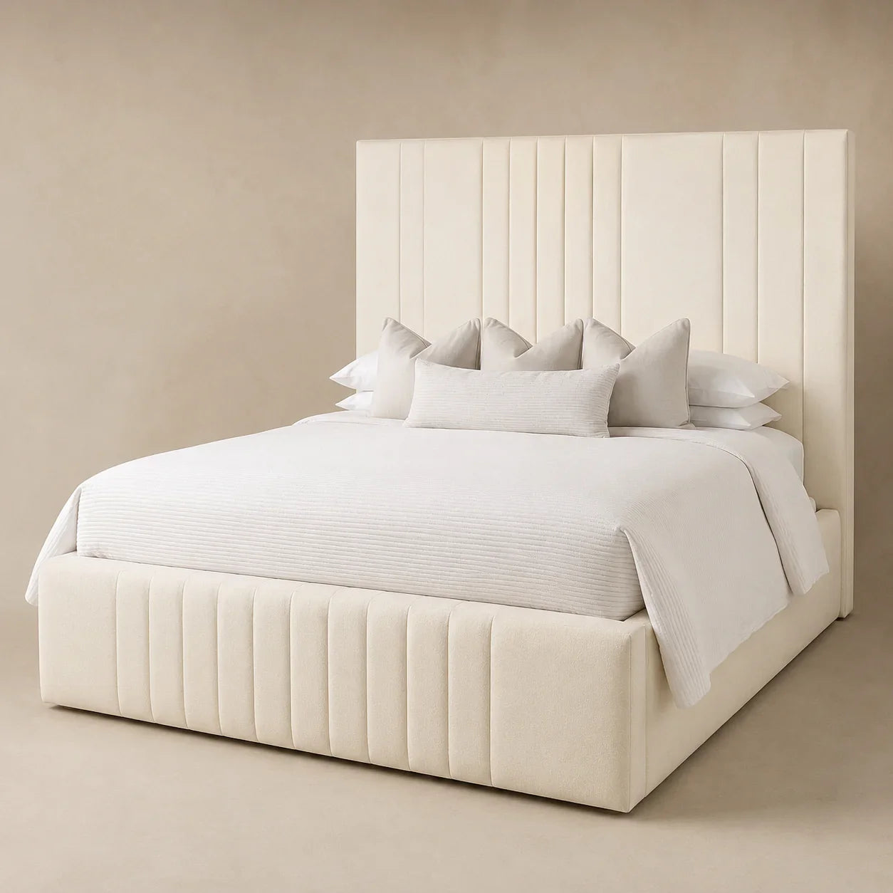 Luxury cream upholstered bed with tufted headboard and base, styled with white bedding and pillows