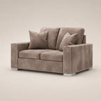 Luxury grey velvet two-seater sofa with nailhead trim and matching cushions, ideal for modern living rooms.