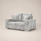 Luxury gray velvet two-seater sofa with nailhead trim and matching cushions, ideal for modern living rooms.