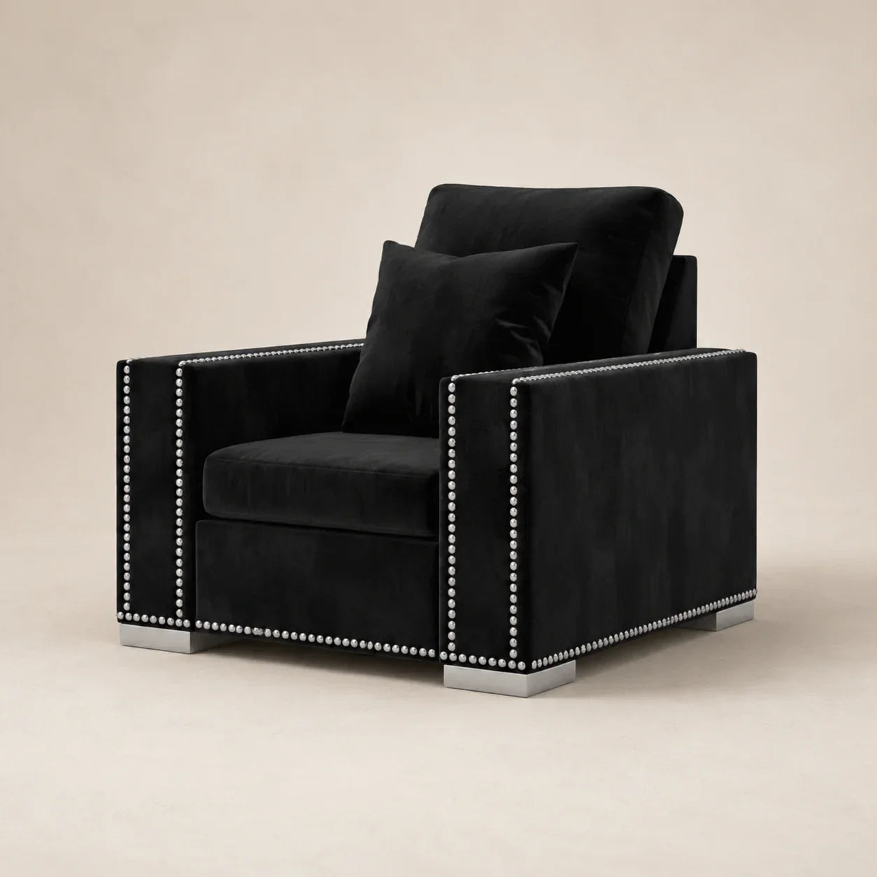 Black velvet armchair with silver nailhead trim and matching pillow, luxury living room furniture