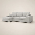 Light gray sectional sofa with chaise lounge and nailhead trim, luxury living room furniture