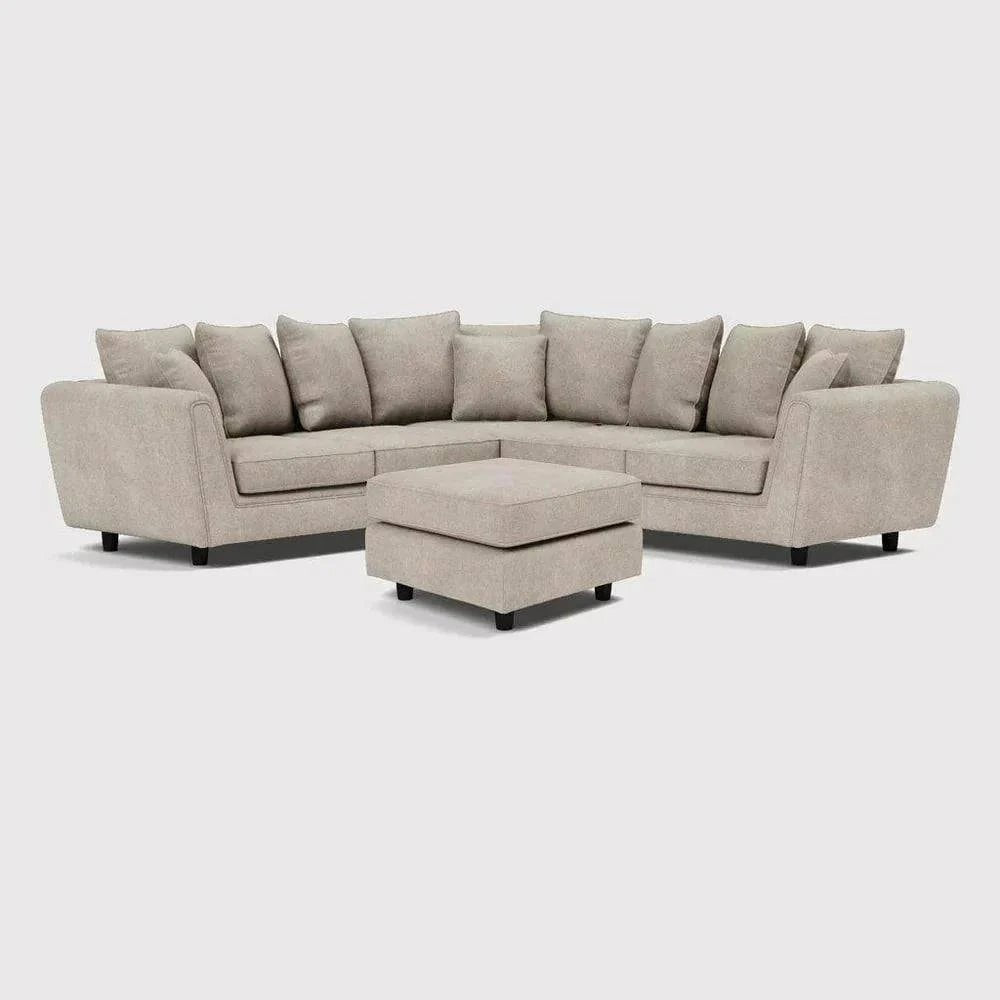 Modern beige double corner sofa with matching footstool, plush cushions, and fabric upholstery.