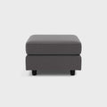 Modern grey fabric footstool with black legs on white background