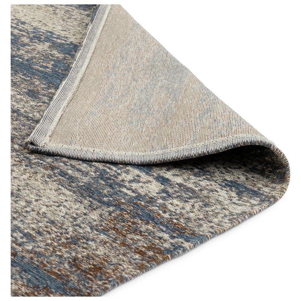 Blue and beige patterned area rug with textured weave and folded corner detail