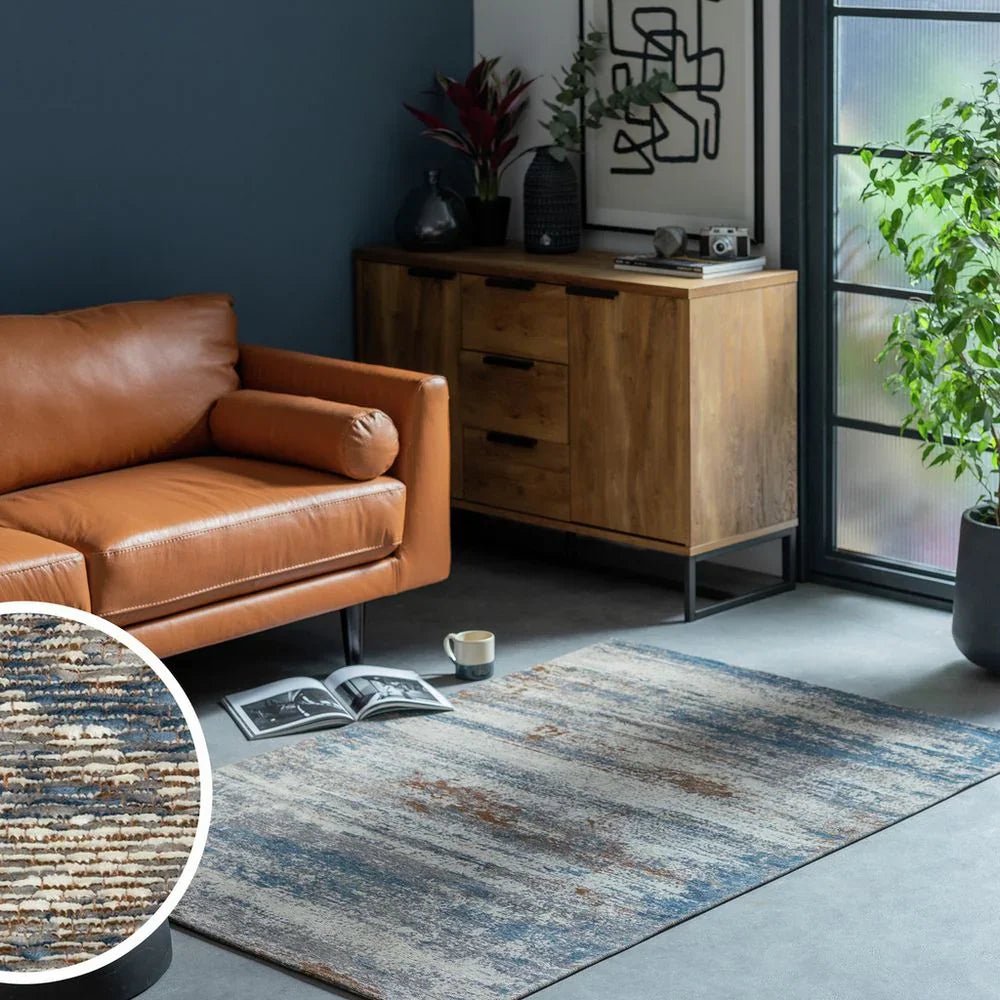 Luxury brown leather sofa with modern abstract rug in stylish living room setting