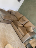 Modern beige corner sofa with chaise lounge and cushions in a contemporary living room