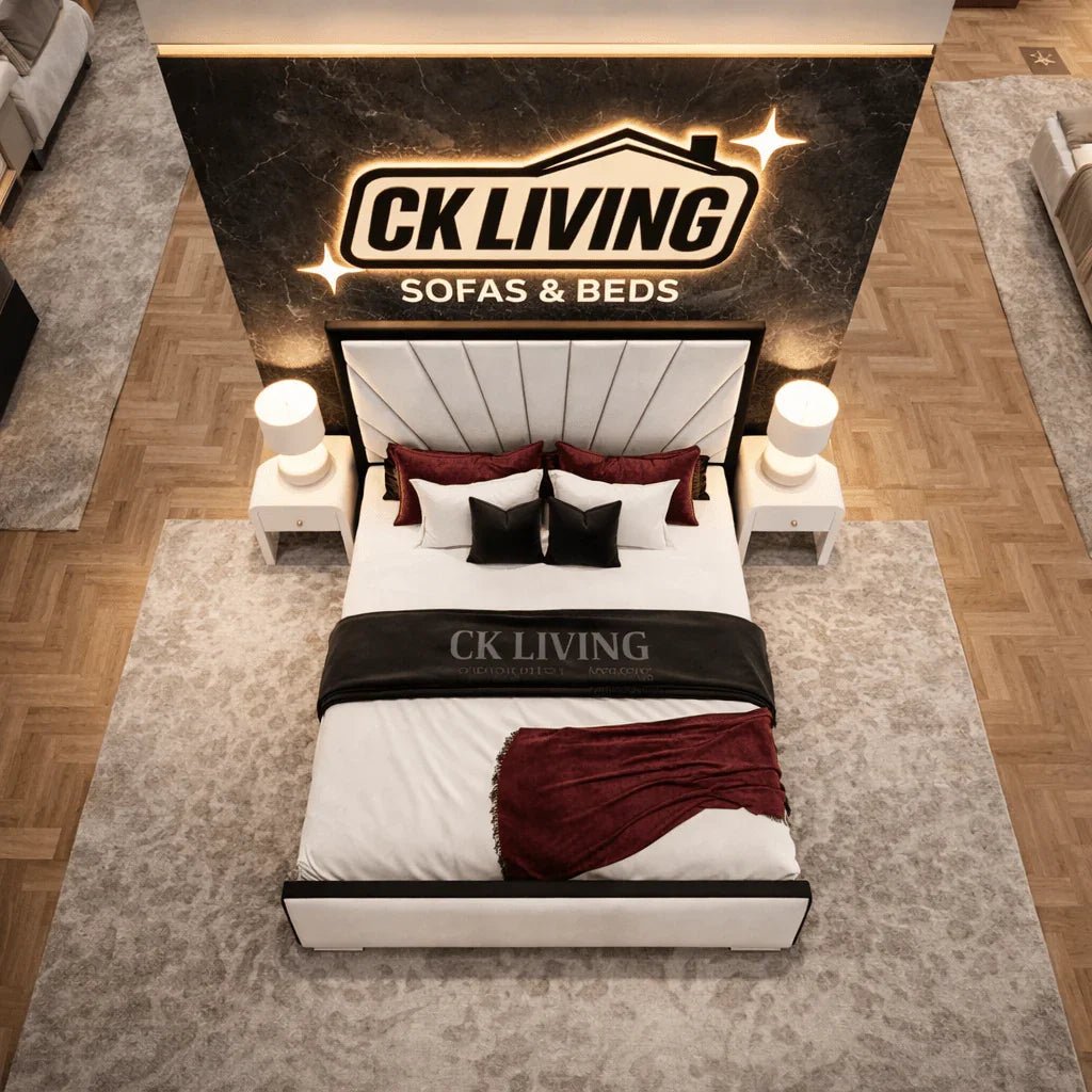 Luxury white upholstered bed with red accents, displayed in CK Living showroom with branded backdrop