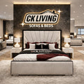 Luxury upholstered bed with tufted headboard in modern showroom, CK Living Sofas & Beds display