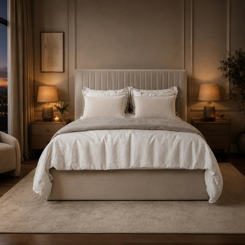 Luxury upholstered bed with tufted headboard, neutral bedding, and warm bedside lamps in modern bedroom