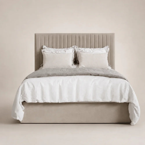 Luxury beige upholstered bed with tufted headboard, white linens, and neutral bedding for modern bedrooms