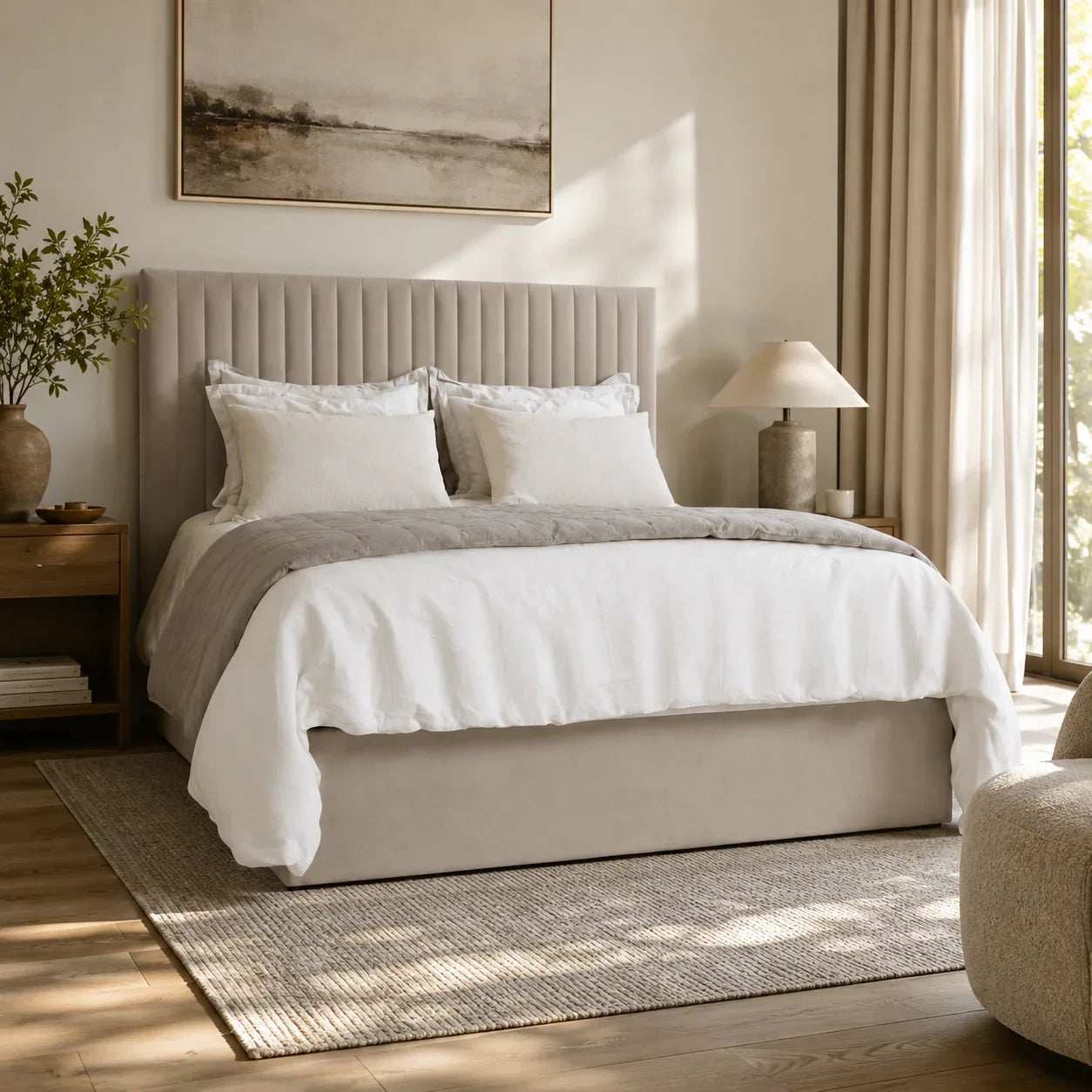 Luxury upholstered bed with tufted headboard, white linens, and neutral bedroom decor