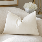 Cream velvet throw pillow on textured sofa, luxury home decor with white hydrangeas