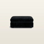 Black velvet ottoman for luxury living room seating, modern design with plush cushioning