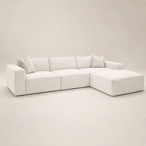Luxury white sectional sofa with chaise and plush cushions, modern minimalist design